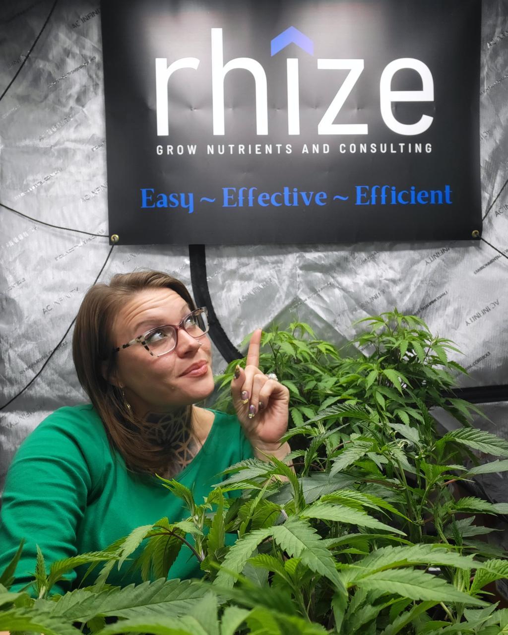 Happy grower @shield_maidens_garden surrounded by lush cannabis plants cultivated with Rhize Nutrients. Testimonial appreciates the simplicity and effectiveness of Rhize, praising their customer support and the comprehensive nutrient system."