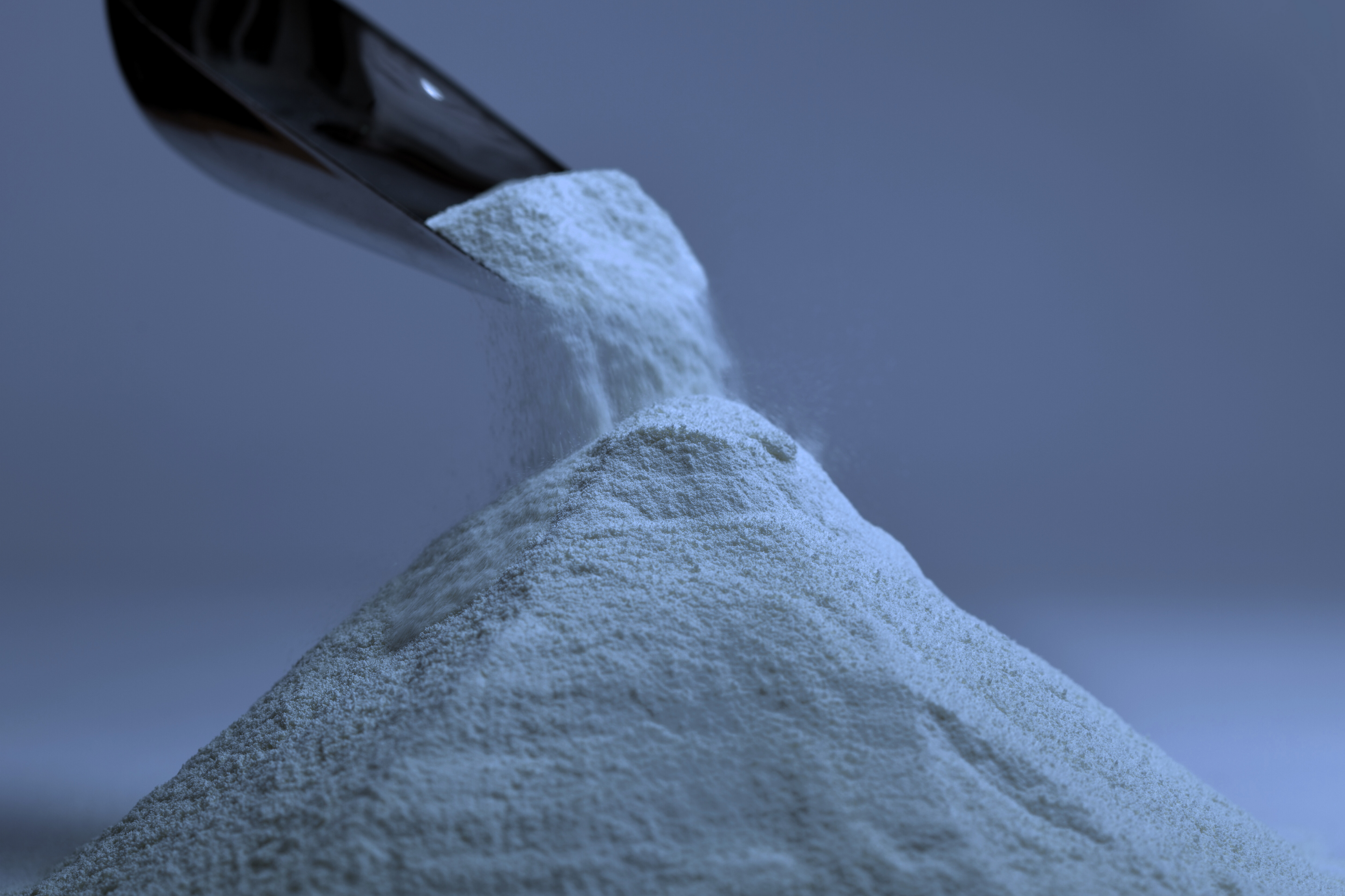 Close-up of Rhize Nutrients powder being poured, illustrating the fine texture and quality of the nutrient blend.